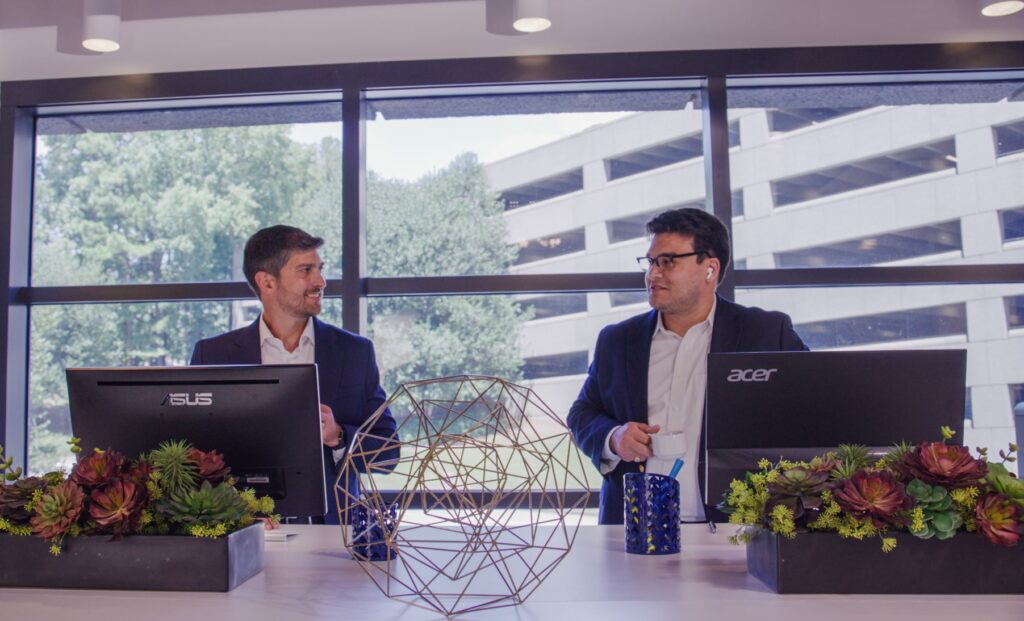 Two experts discussing mergers and acquisitions at Walden M&A